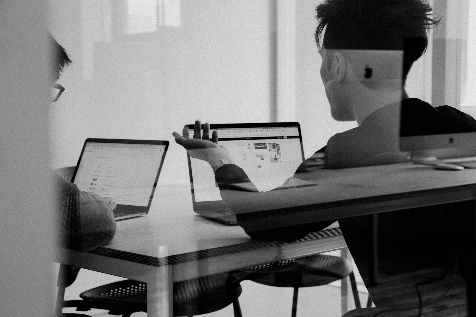 Advisers reviewing a file together at a meeting table